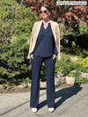 Miik model Johanna (size XS, five foot six) wearing Sierra high waisted pocket pant in navy as a pant suit with a matching top and blazer.