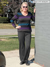 Woman standing next to a building wearing Miik's Sina straight leg pant in charcoal with a top.