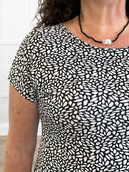 A closeup detail of the reversed neckline of Miik&