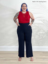 Miik model Kaitlin (5'9", xlarge) laughing wearing Miik's Teanna scoop neck tank top in poppy red with a navy pant