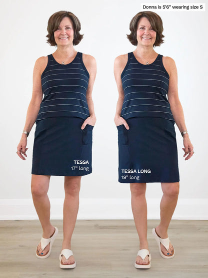 Woman modeling side by side images of the Tessa high waisted pocket skort in navy, in regular vs. long length.