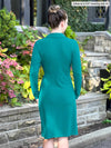 Miik model Johanna (5’6”, xsmall) standing with her back towards the camera showing the back of Miik's Tierney collared faux wrap dress in jade melange