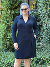 Miik model Katlin standing on nature wearing Miik's Tierney collared faux wrap dress in navy