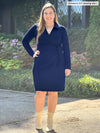 Miik model Christal (5'3", large) wearing Miik's Tierney collared faux wrap dress in navy and boots