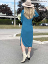 Woman Woman standing with her back towards the camera showing the back of Miik's Verona long sleeve boat neck in teal melange