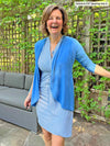 Miik founder Donna laughing wearing Miik's Wesson 2-in-1 cover up dress in cobalt mini stripe along with a cropped cardigan in cobalt melange 