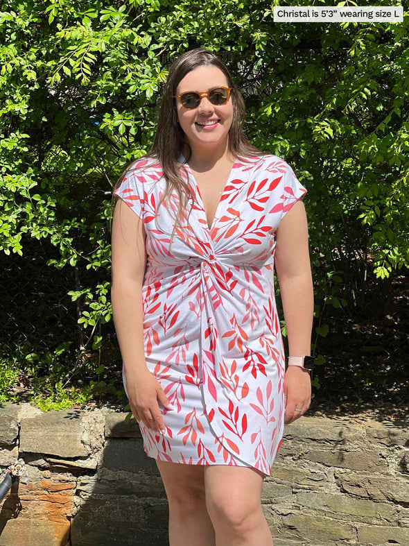 Woman standing in nature smiling while wearing Miik's Wesson 3-in-1 cover up dress in pink leaf pattern