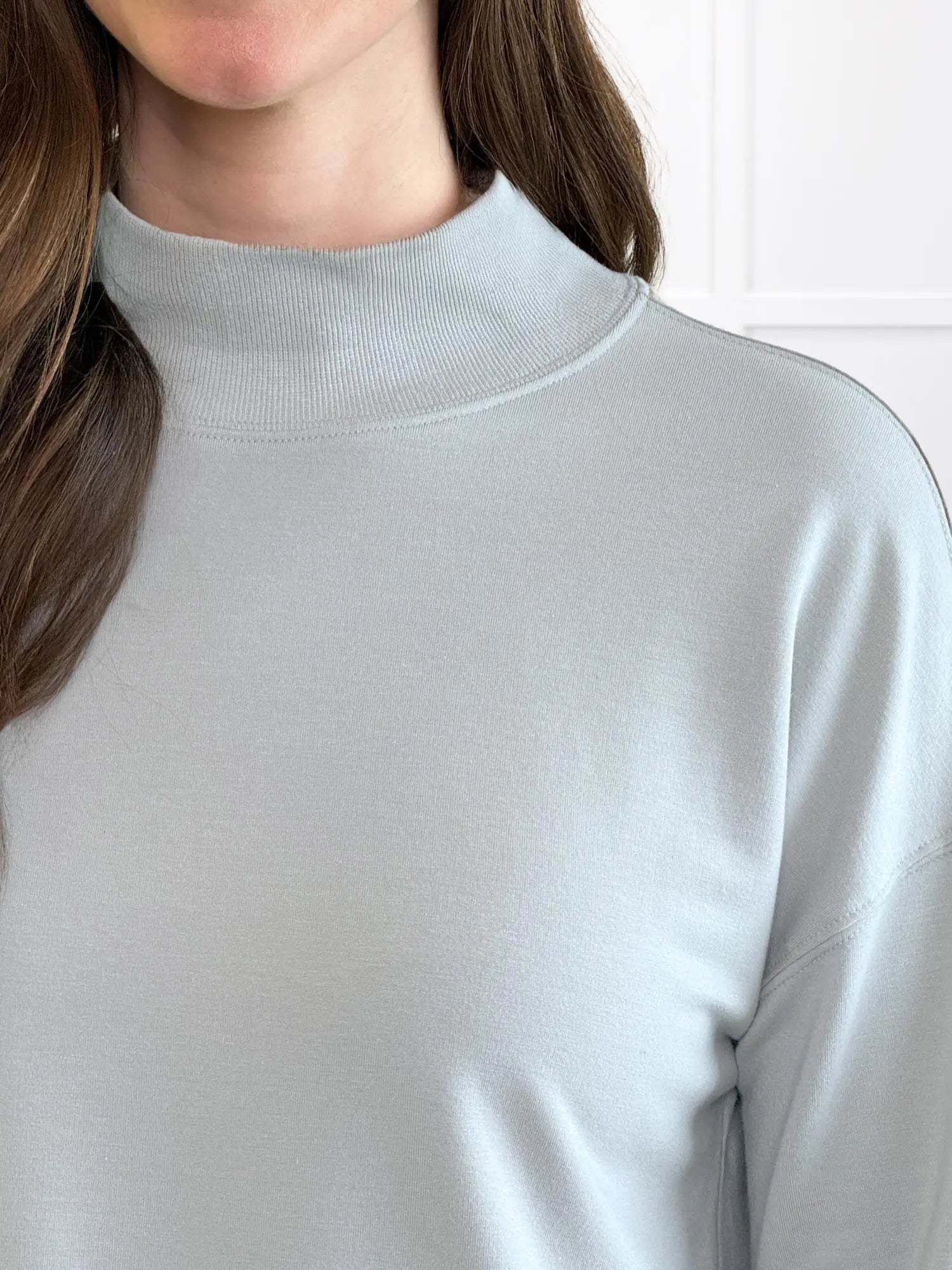 A closeup detail of the neckline of Miik&