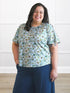 Brielle flutter sleeve top 00 in Forest veil on model Sarita, size 2X @Sarita-2x 