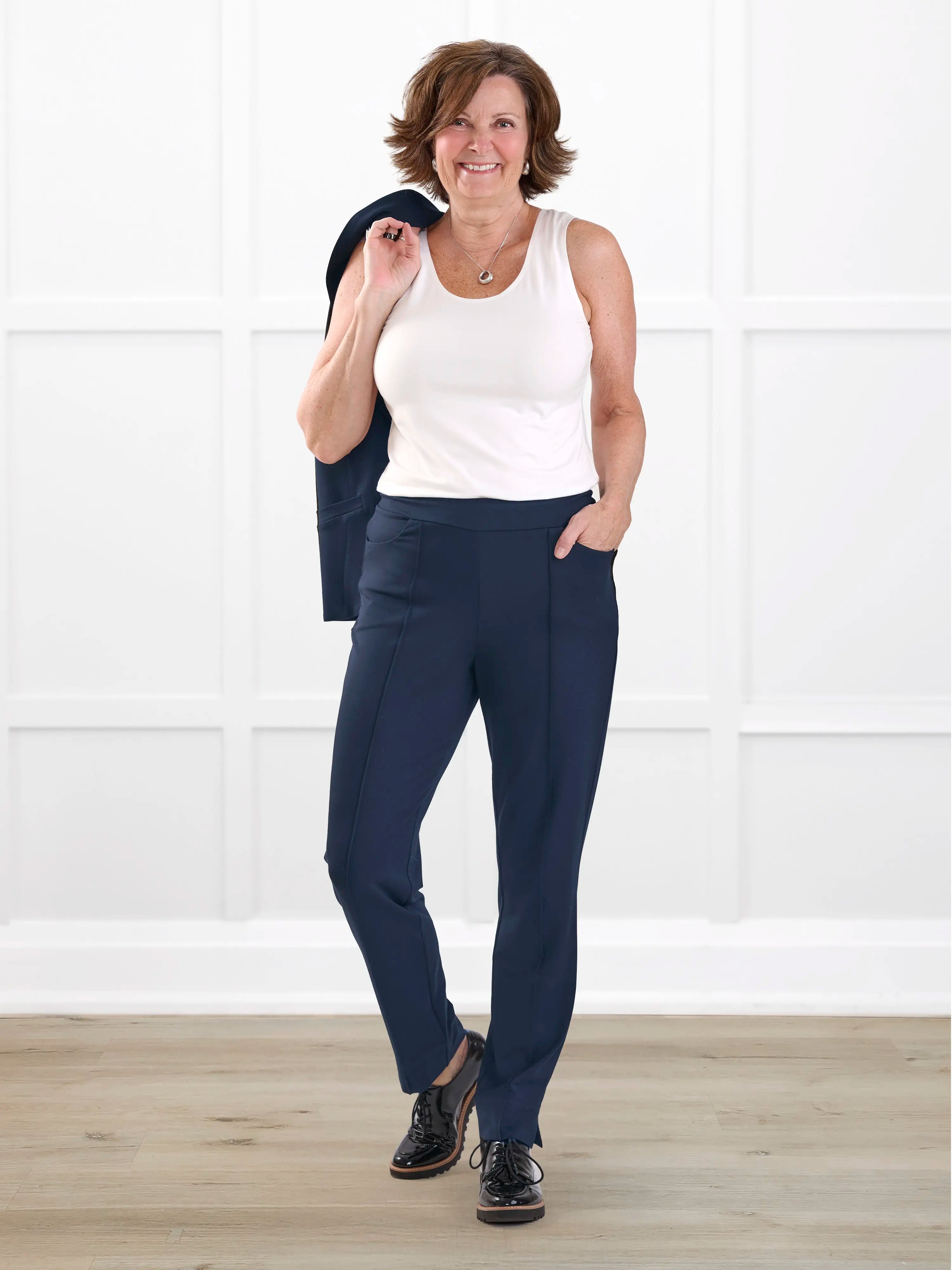 Christal pull on pintuck ankle pant in Navy on model Donna, size S Regular @Donna-S-regular 
