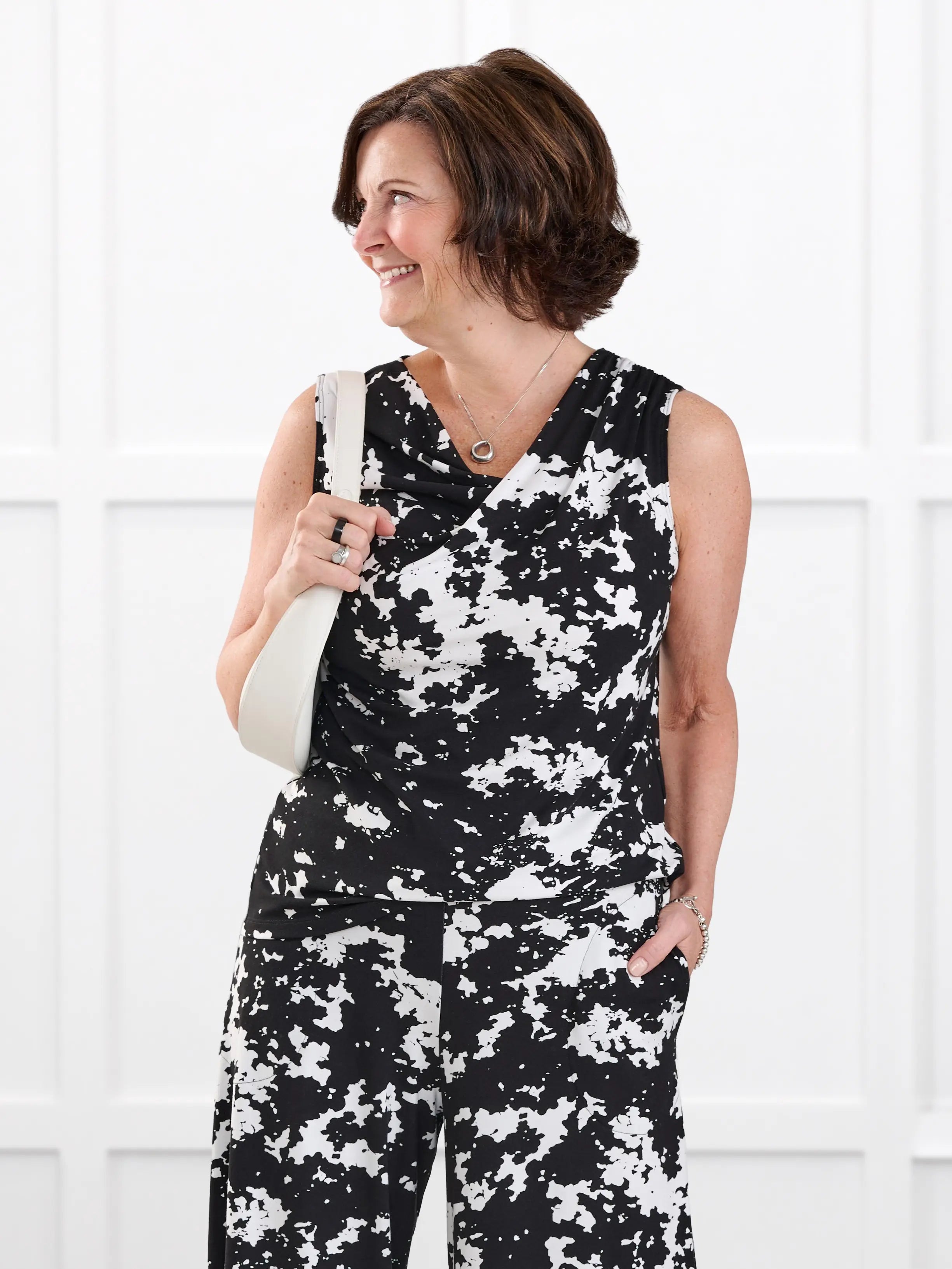 Dion sleeveless draped dressy top for women in Moo’d bloom on model Donna, size S @Donna-S 