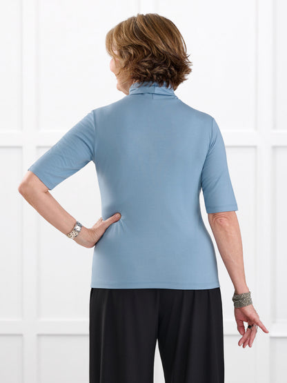 Halima half sleeve turtleneck top for women in Steel blue on model Donna, size S @Donna-S 