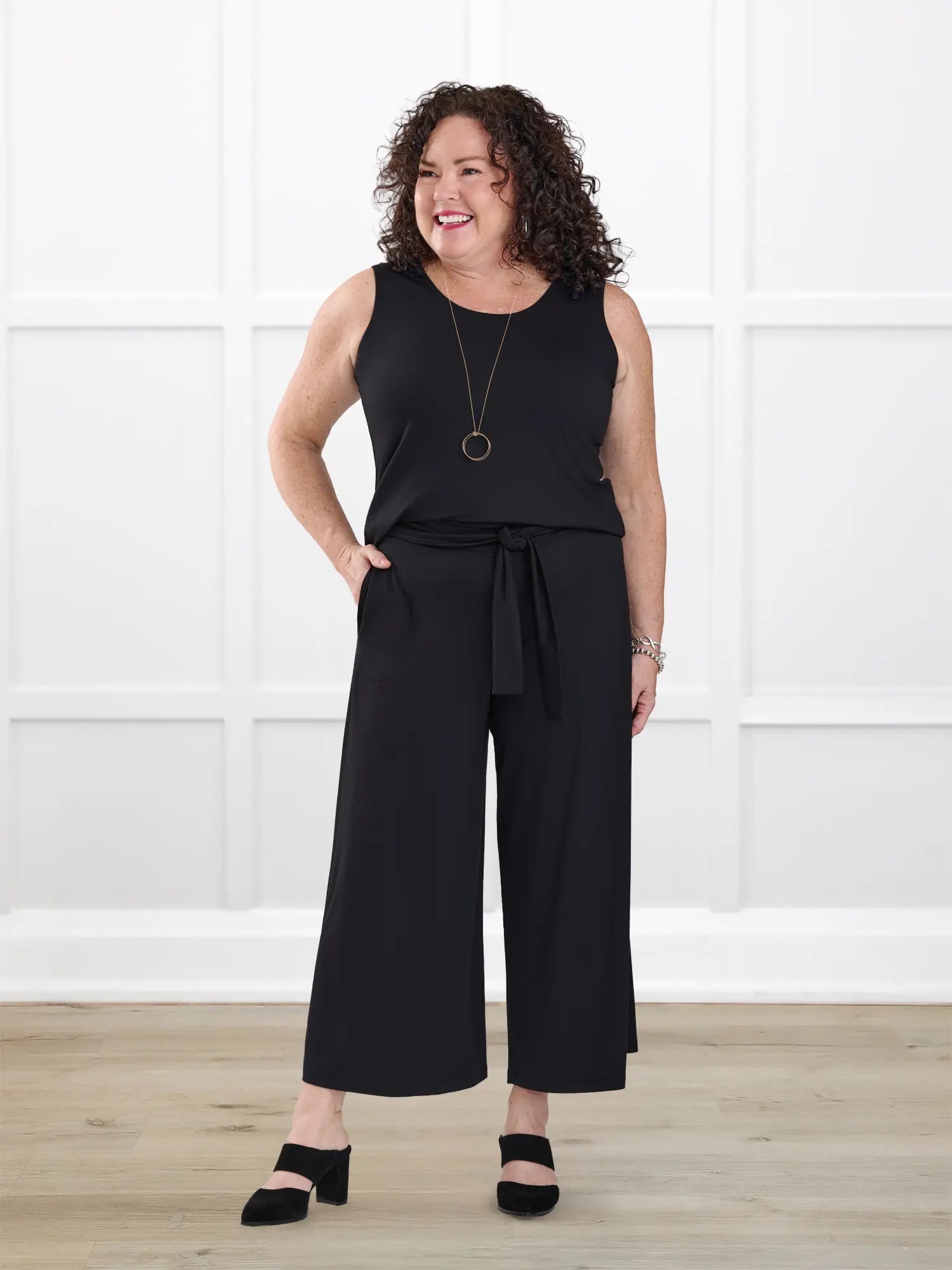 Kavita open back capri jumpsuit for women in Black on model Kerri, size M @Kerri-M-petite 