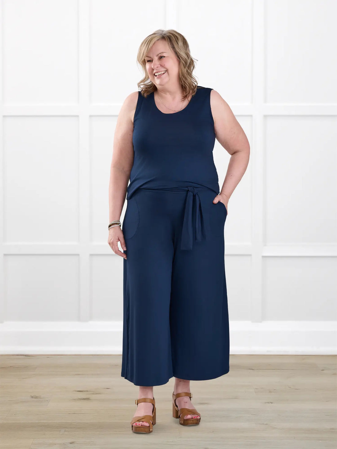 Kavita open back capri jumpsuit for women in Navy on model Deb, size XL @Deb-XL-regular 