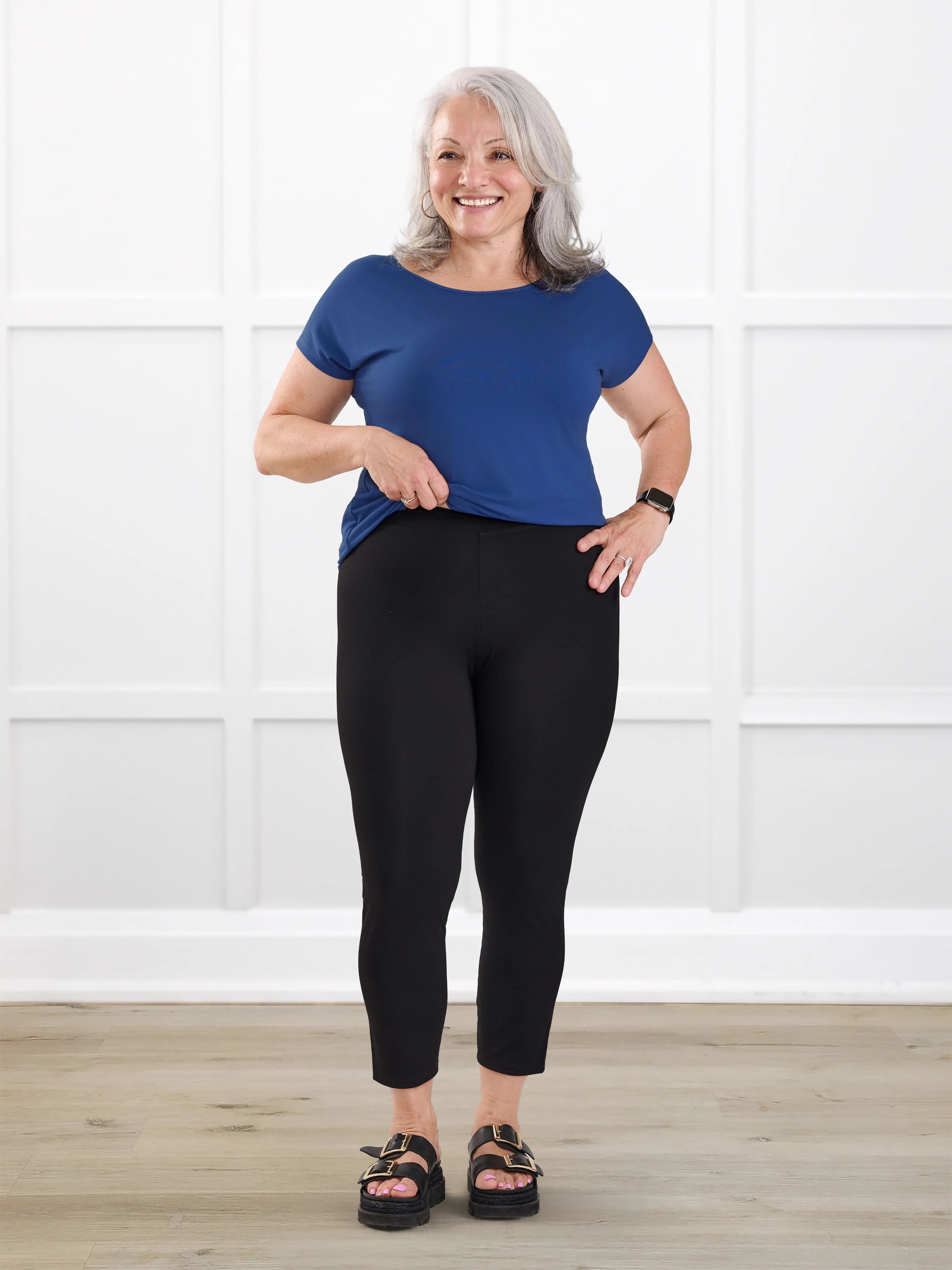 Lucy mid rise capri legging for women in Black on model Rula, size L @Rula-L 