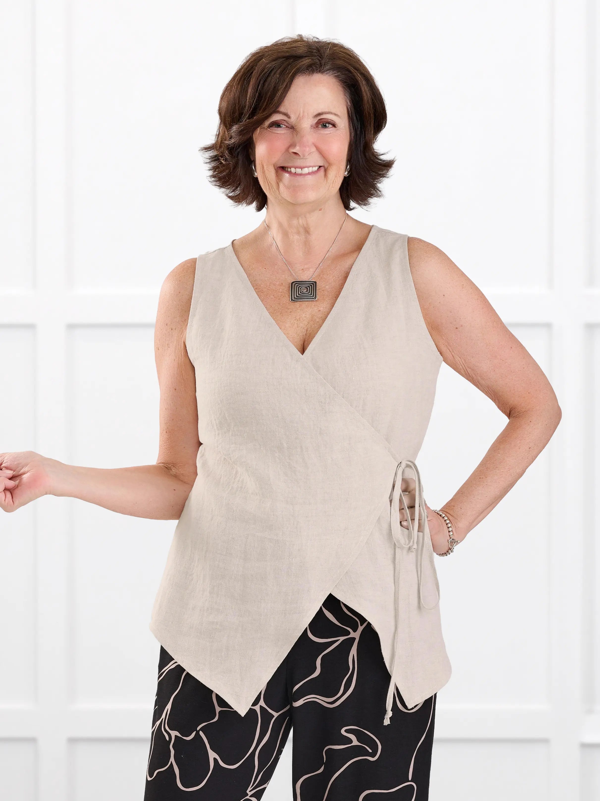 Regina sleeveless linen wrap top for women in Sand linen on model Donna, size S @Donna-S 