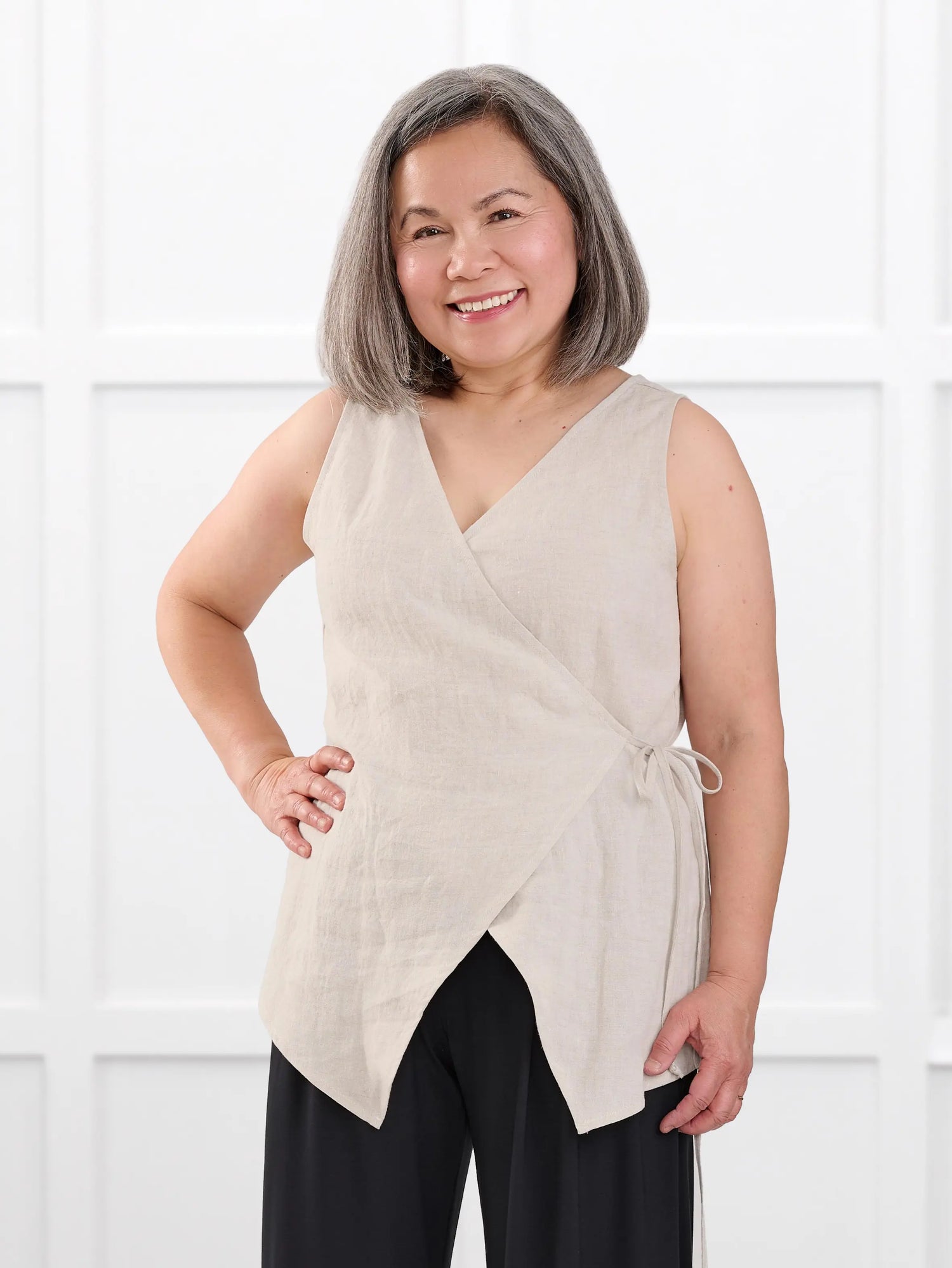 Regina sleeveless linen wrap top for women in Sand linen on model Terry, size S @Terry-S 