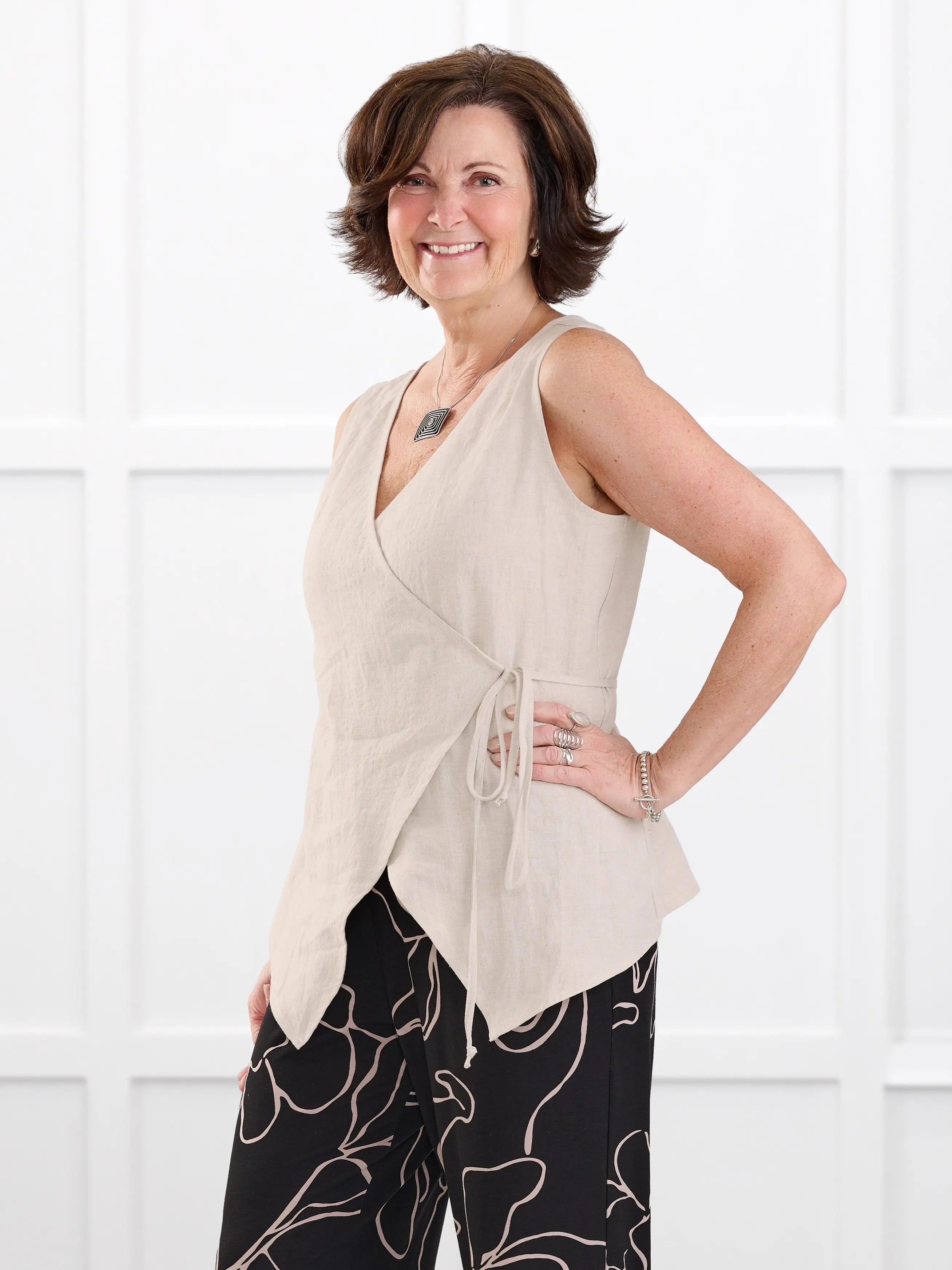 Regina sleeveless linen wrap top for women in Sand linen on model Donna, size S @Donna-S 