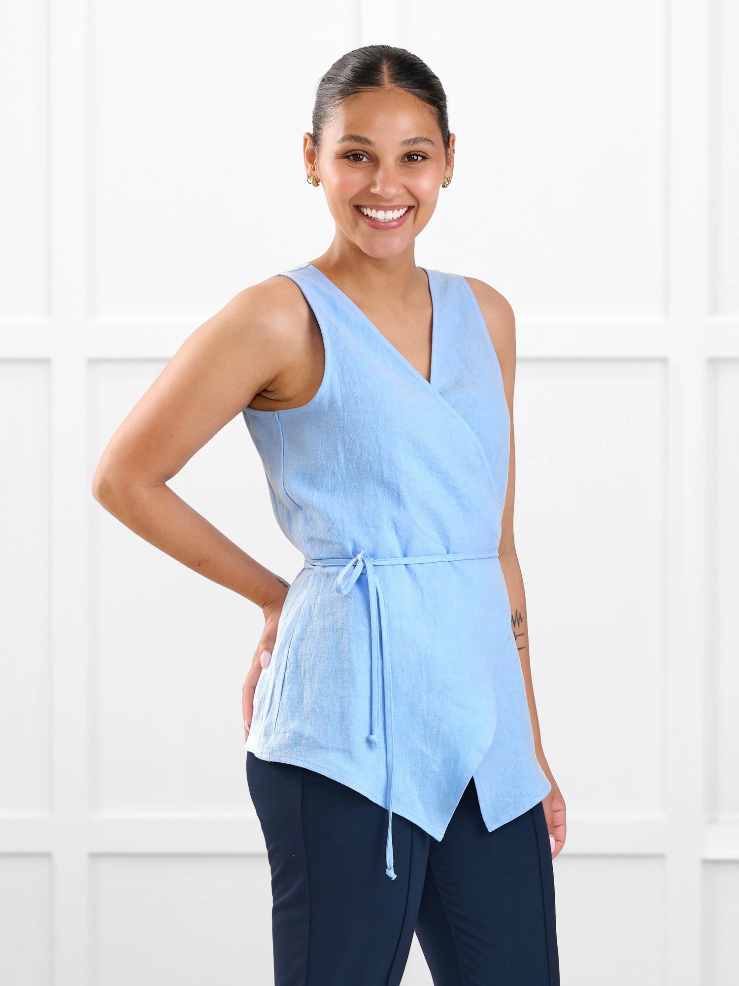 Regina sleeveless linen wrap top for women in Serene blue linen on model Meron, size XS @Meron-XS 