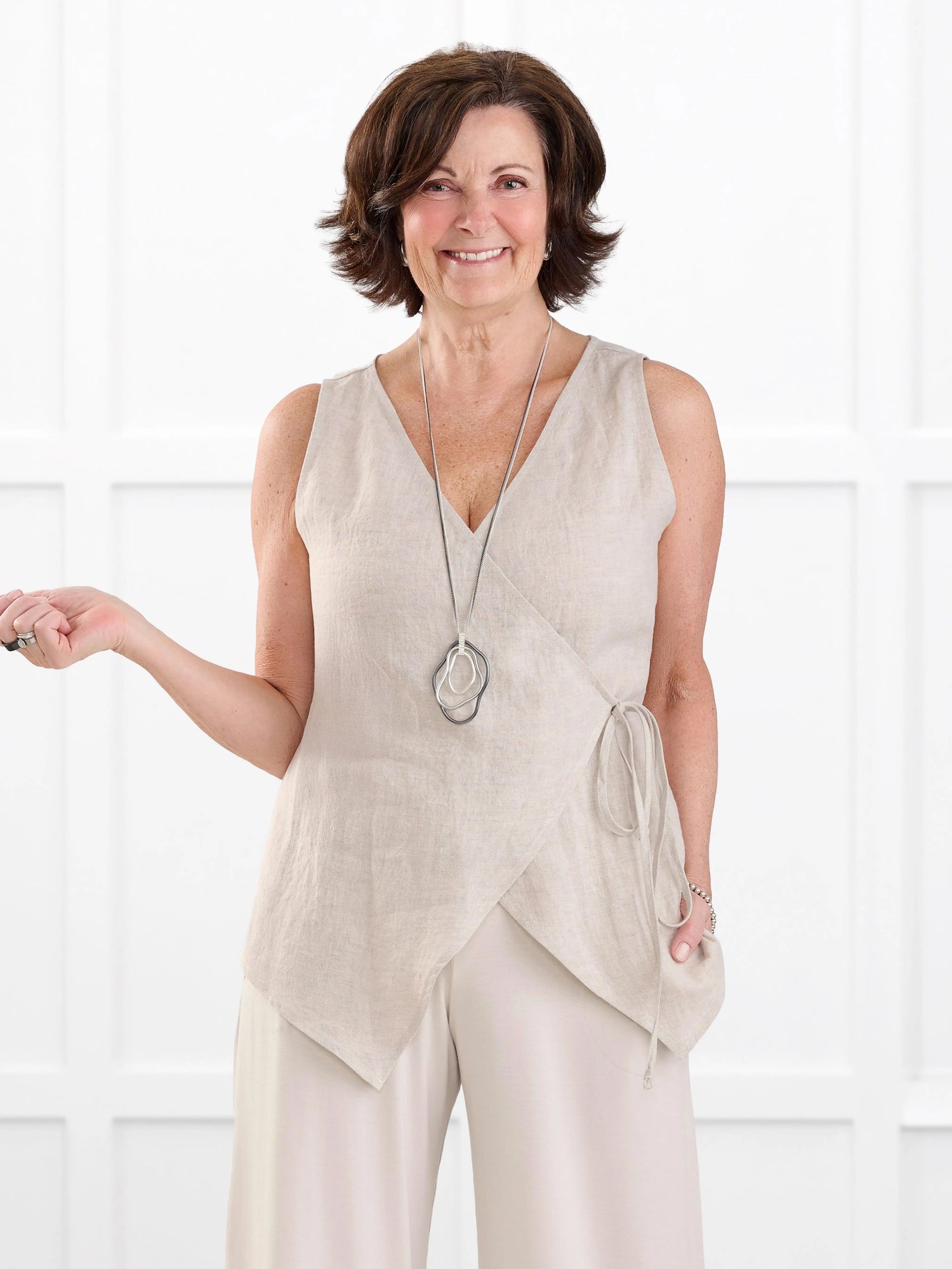 Regina sleeveless linen wrap top for women in Sand linen on model Donna, size S @Donna-S 