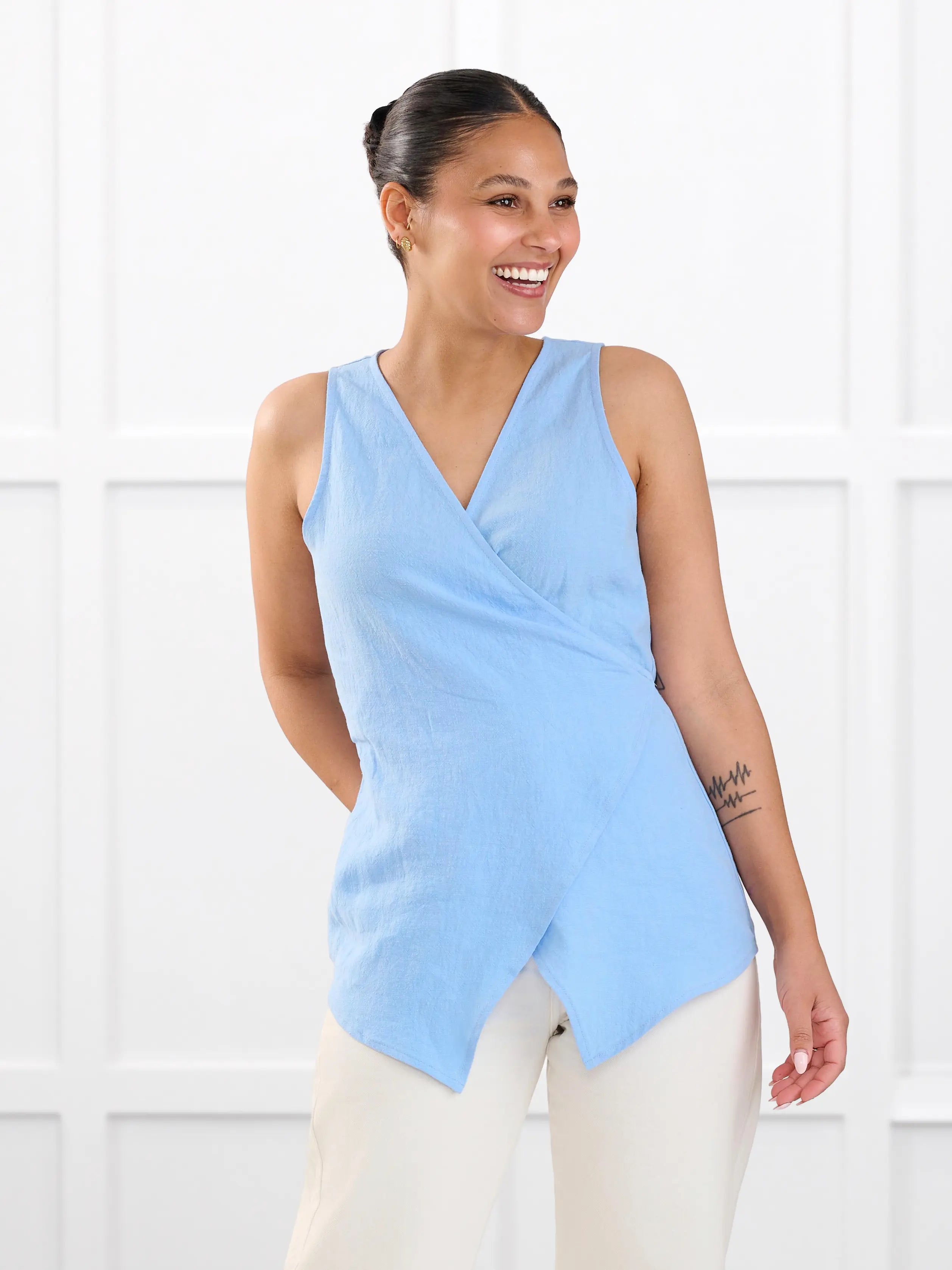 Regina sleeveless linen wrap top for women in Serene blue linen on model Meron, size XS @Meron-XS 