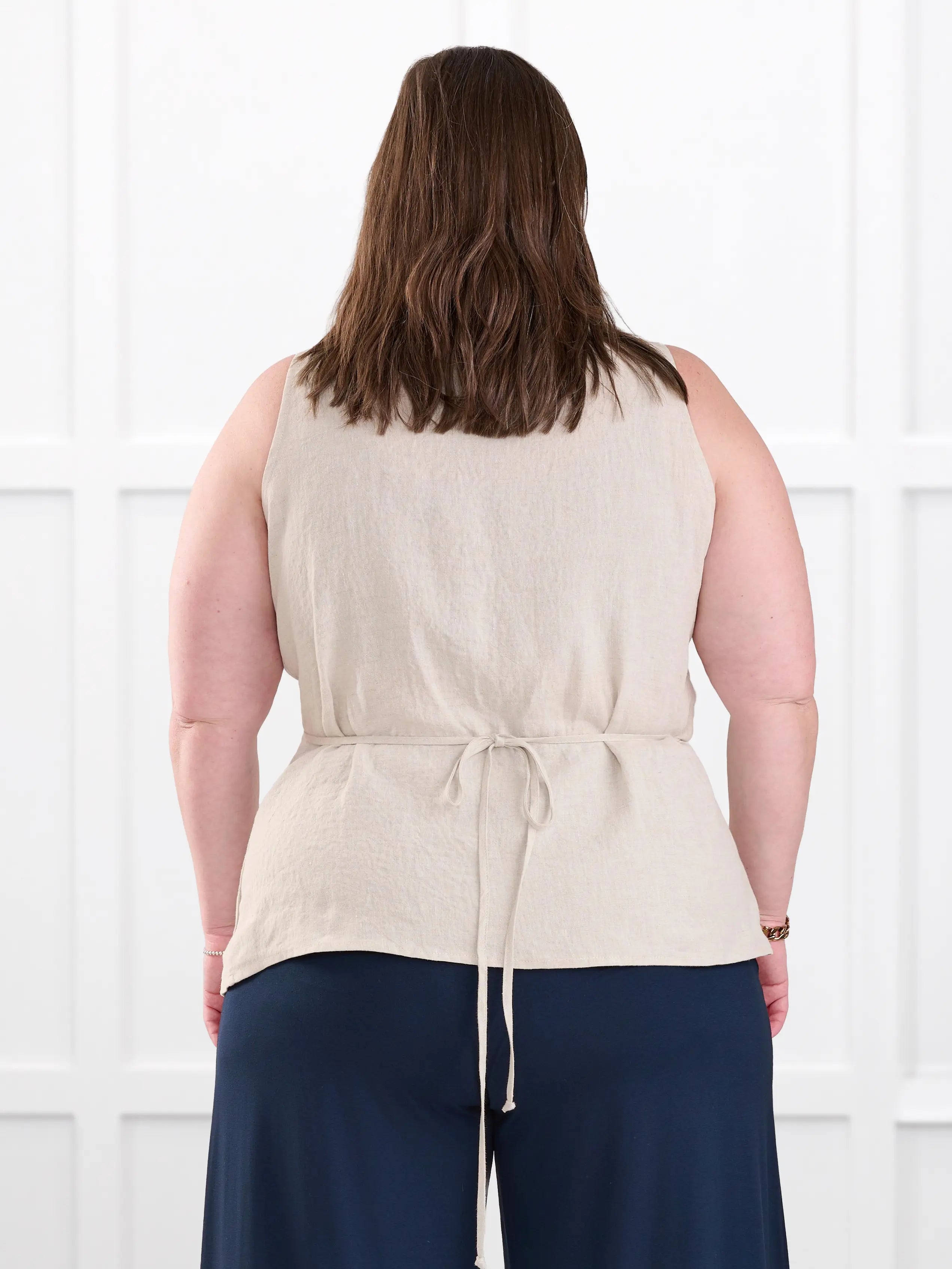 Regina sleeveless linen wrap top for women in Sand linen on model Cristina, size XXL @Cristina-XXL 