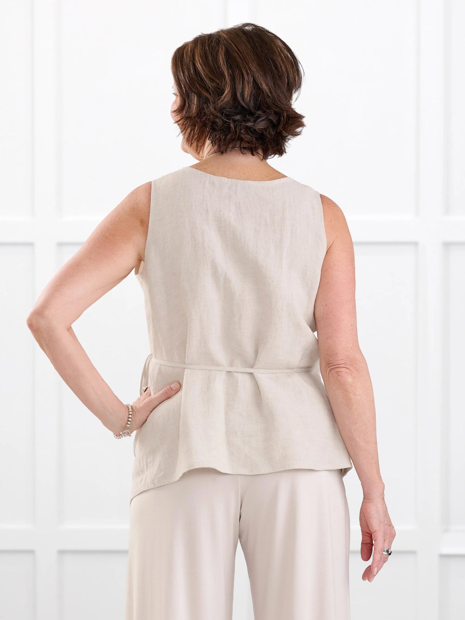 Regina sleeveless linen wrap top for women in Sand linen on model Donna, size S @Donna-S 