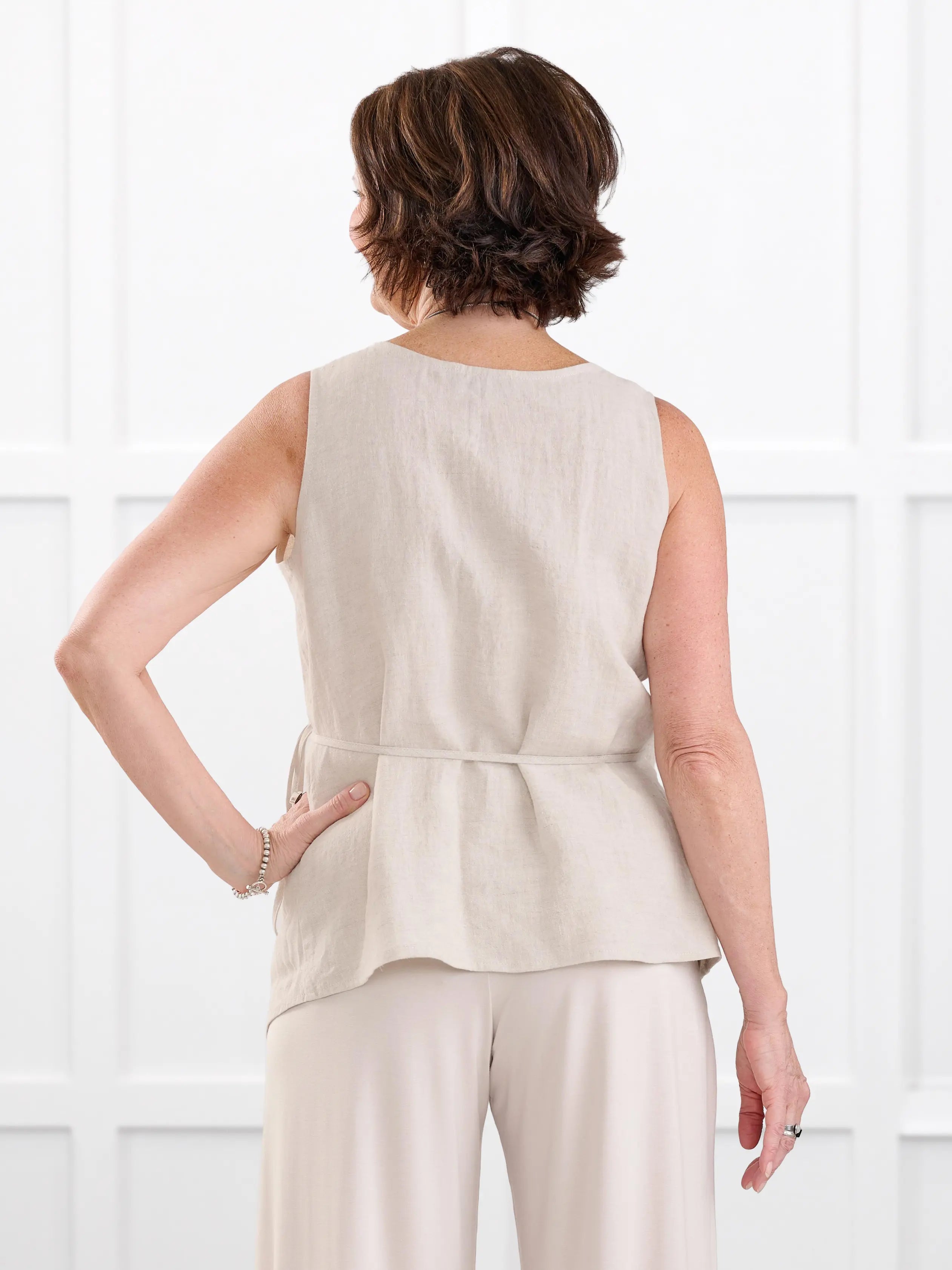 Regina sleeveless linen wrap top for women in Sand linen on model Donna, size S @Donna-S 