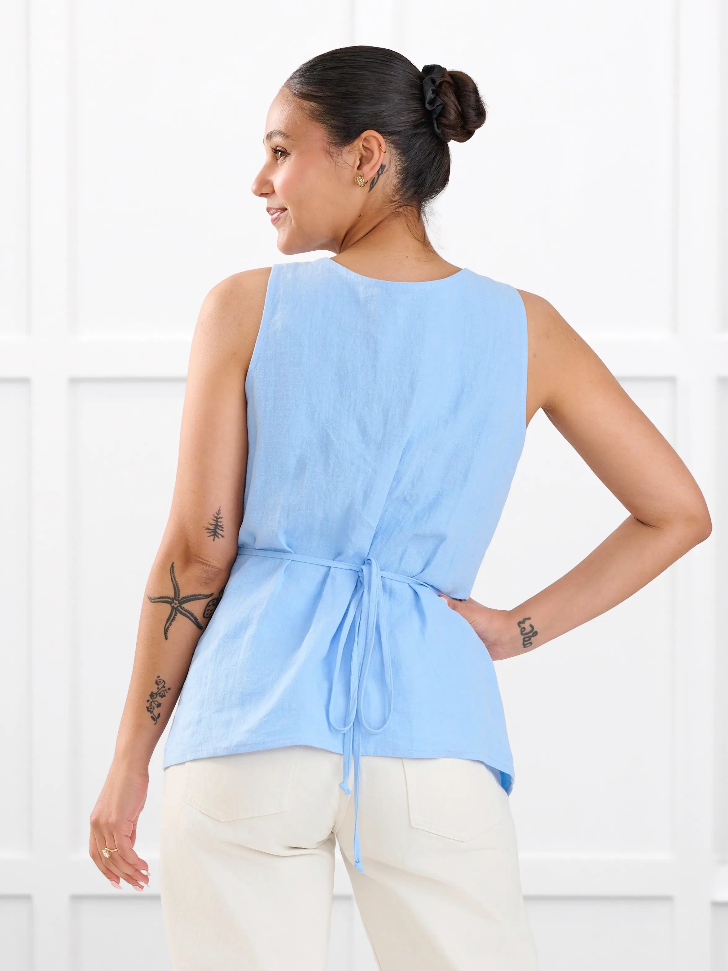 Regina sleeveless linen wrap top for women in Serene blue linen on model Meron, size XS @Meron-XS 