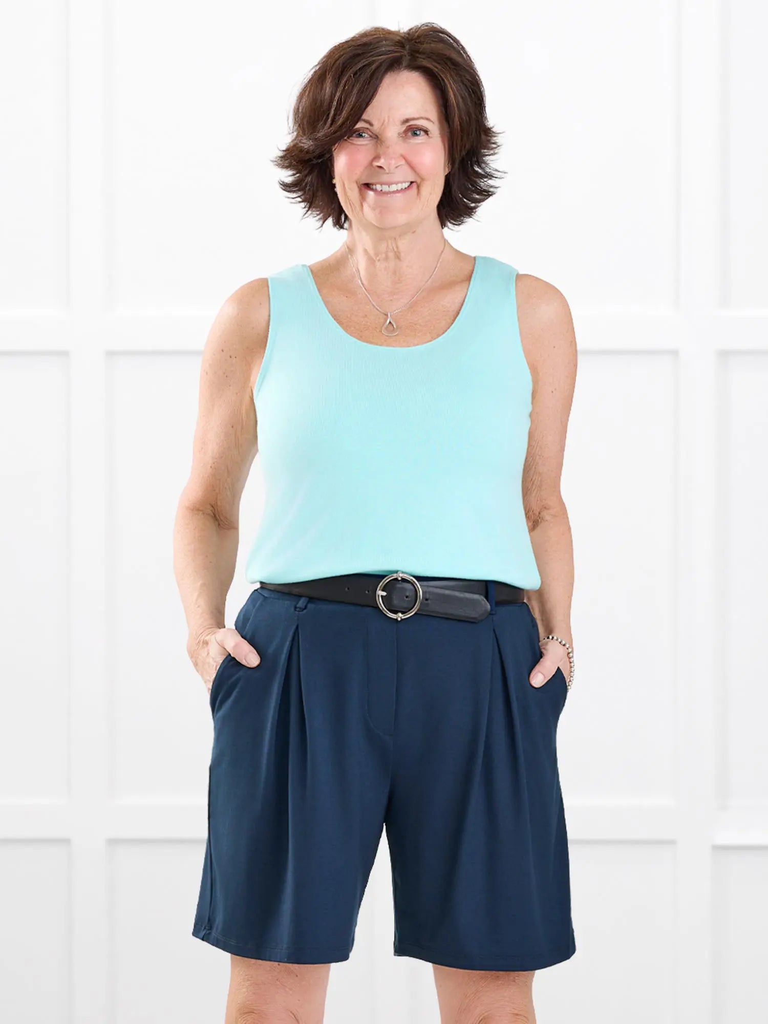 Saleema tailored pleated short for women in Navy on model Donna, size S @Donna-S 