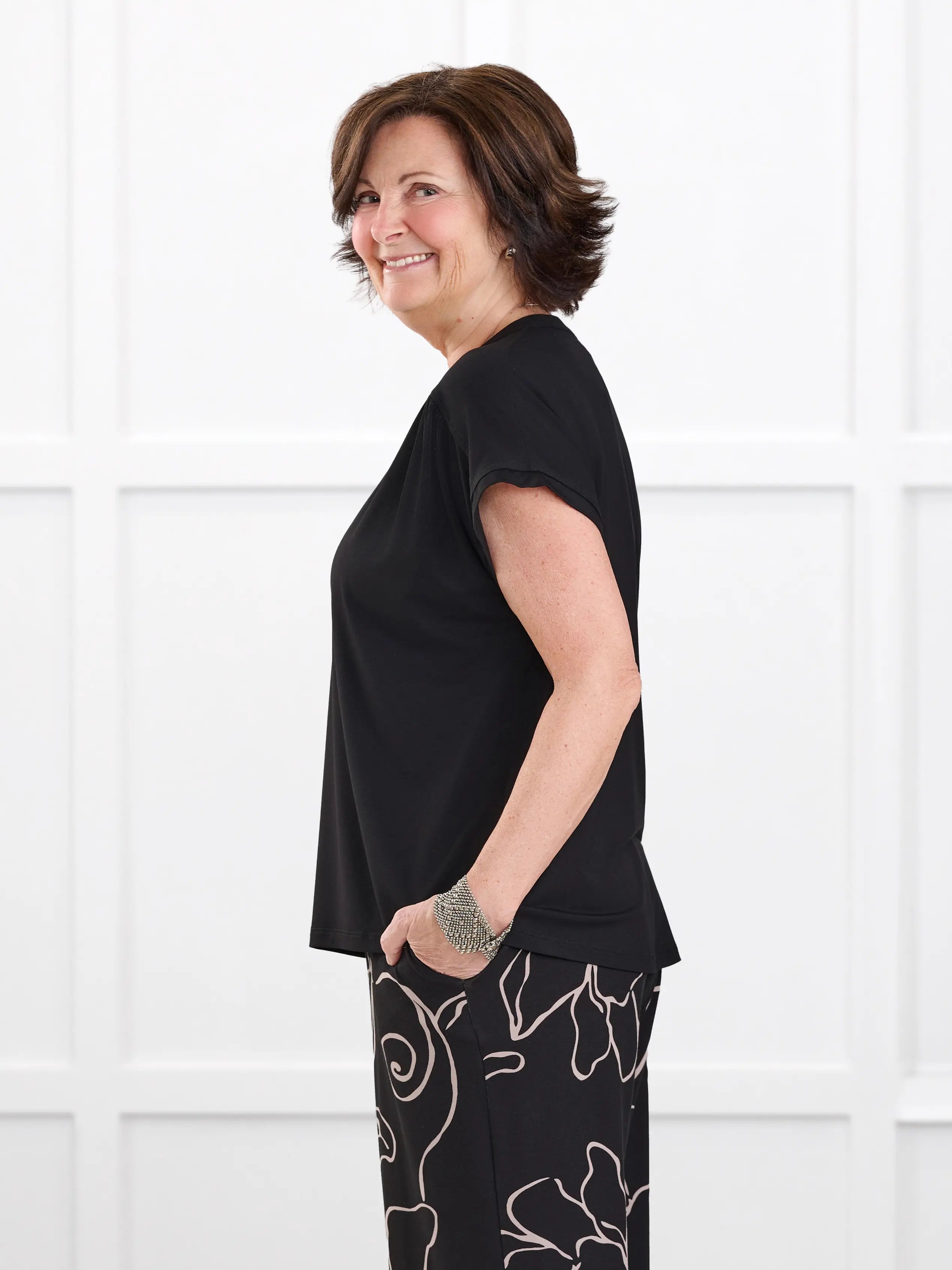 Triana ruched v neck dolman top for women in Black on model Donna, size S @Donna-S 