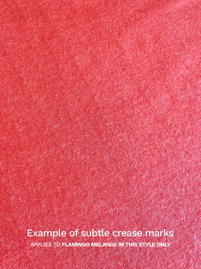 A close-up of the flamingo melange fabric of the Yuki top, showing the fabric irregularities. In this instance, it shows an example of the subtle crease marks that cannot be ironed out. 