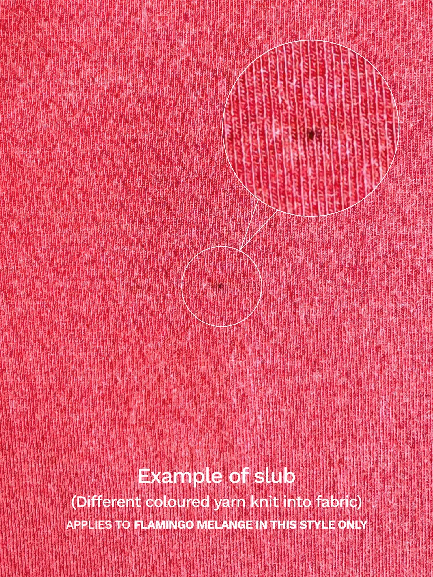 A close-up example of a slub in the flamingo melange fabric of the Yuki tank, showing a spot of different coloured yarn knit into the fabric. 