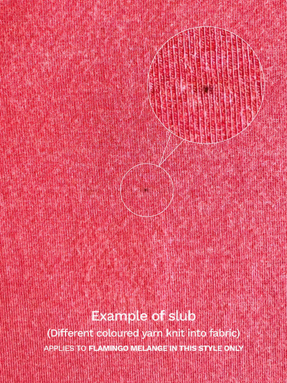 A close-up example of a slub in the flamingo melange fabric of the Yuki tank, showing a spot of different coloured yarn knit into the fabric. 