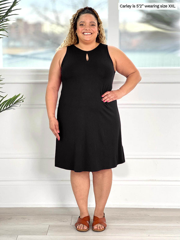 Miik model Carley (size xxlarge, five foot two) wearing the a-line Aubrey swing dress in black with the keyhole in the front.