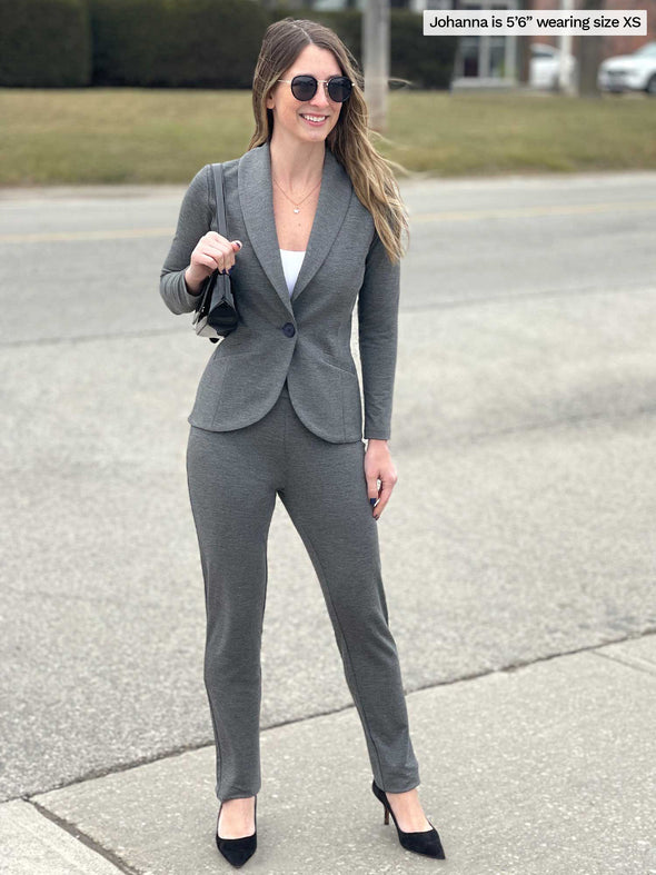 Woman smiling standing in a sidewalk wearing Miik's Avery pull-on pant in granite melange french terry along with a matching blazer and a white tank, high heels and sunglasses