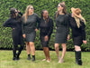 Group of women laughing standing in nature wearing Miik's Bali bat sleeve dress black and charcoal