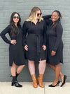 Three women standing in front of s brick wall wearing Miik's Finian collared shirt dress in black