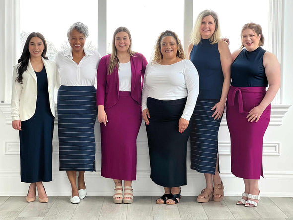 Six Miik models all wearing Miik's Frankie midi skirt in all colours available: navy, navy wide pinstripe, ruby and black. This image is an informational image to show the fitting of the skirt in all different body shapes and sizes 