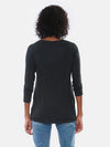 Woman standing with her back towards the camera wearing Miik's Harmony twisted hem top in black with jeans.