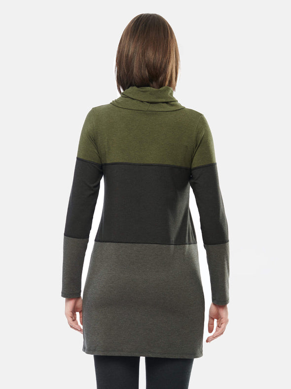 Woman standing with her back towards the camera wearing Miik's Hasha colourblock twisted cowl tunic in grey green stripe and leggings.