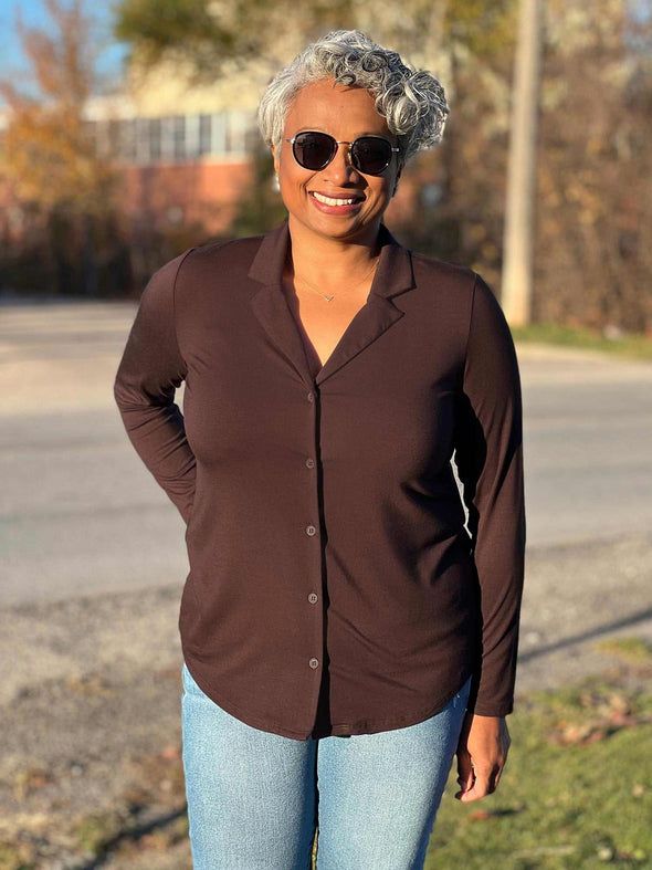 Women smiling wearing Miik's Keeley notched collar long sleeve blouse in dark chocolate, jeans and sunglasses 