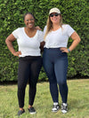 Two women standing in nature wearing Miik's Lisa 2 legging in black and navy with a white t-shirt