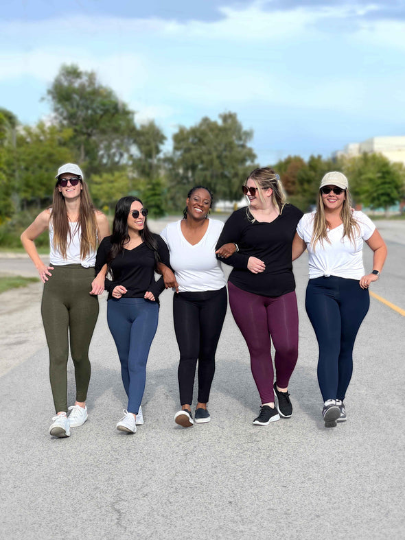 Five women walking in the middle of the road having fun while wearing Miik's Lisa2 colourful high waisted legging: sage melange, navy melange, black, port melange and navy