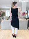 Woman standing with her back towards the camera showing the back of Miik's Mariska asymmetrical tunic dress in black and white jeans 