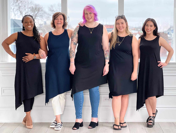 Group of five women all wearing Miik's Mariska asymmetrical tunic dress in navy and black showing differents ways to style the tunic/dress