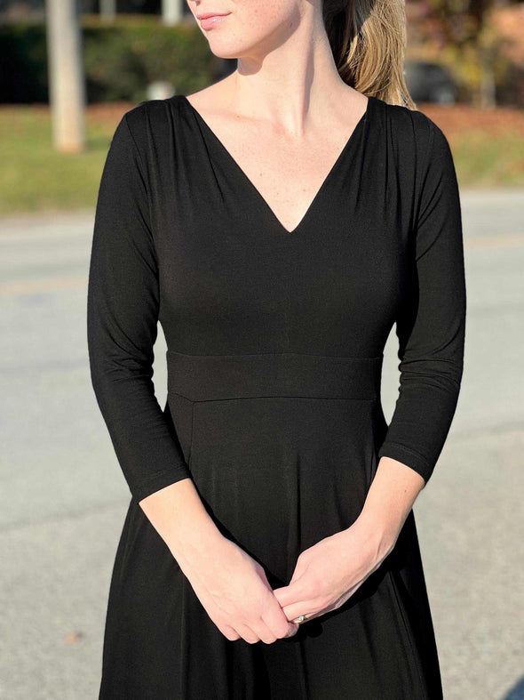 A close up image of the neckline of Miik's Rebel midi flounce dress with pockets in black