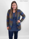 Woman standing in front of a white wall wearing Miik's Rhonda stretchy reversible tunic in navy melange with a waterfall striped cardigan and navy legging 