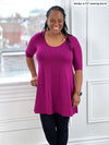 Woman smiling wearing Miik's Rocelle half-sleeve scoop neck tunic in ruby with legging
