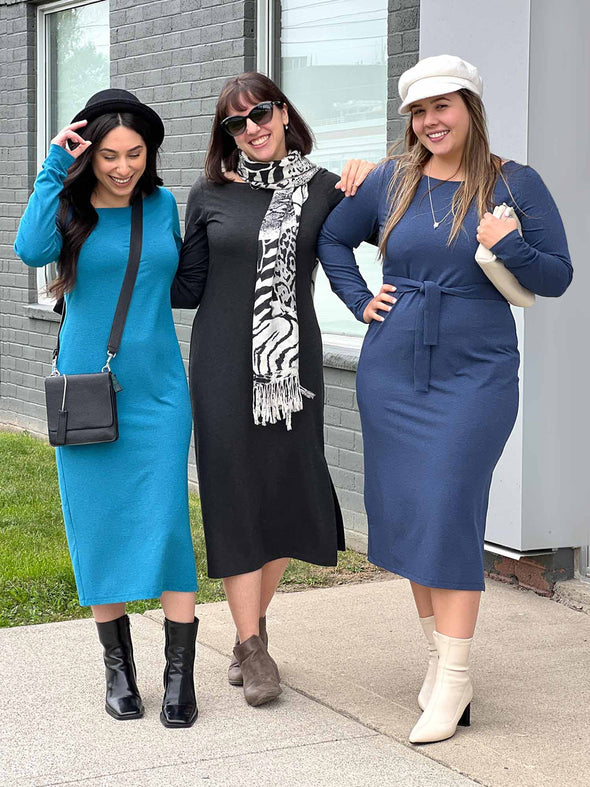 Three women wearing Miik's Verona long sleeve boat neck dress in three different colours: teal melange, charcoal and navy melange